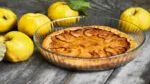 Homemade apple quince pie with fresh fruits on rustic wooden bac